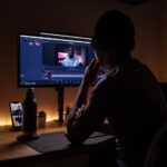 boy in black long sleeve shirt sitting on chair in front of black flat screen tv